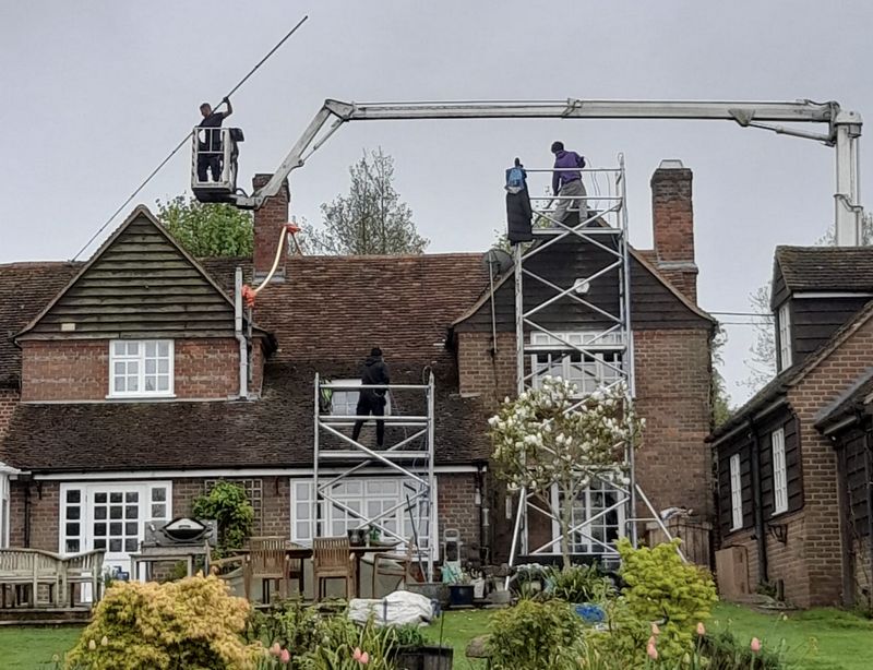 The Moss Cleaners using cherry picker and scaffolding to clean roof safely and professionally in Westergate, West Sussex
